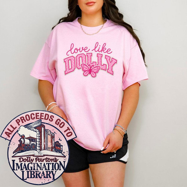 Love Like Dolly DTF Transfer, Retro Varsity Butterfly Design on pink T-shirt worn by a woman.