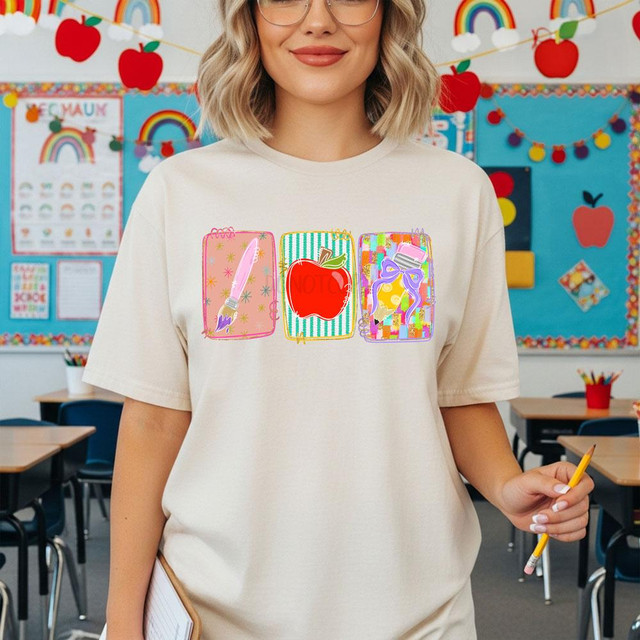 Teacher School Icons DTF Transfer, colorful back to school heat transfer design featuring an apple, a notebook with a bow, and a notebook with a pen for decorating school apparel or accessories.