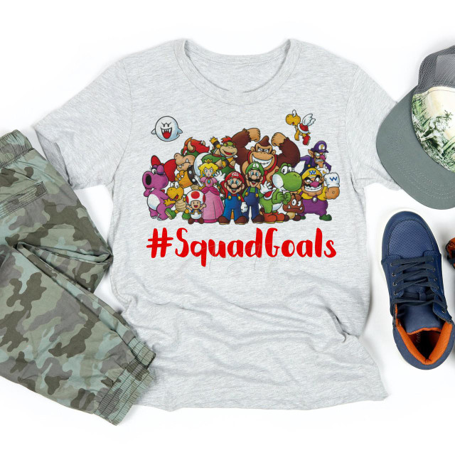 Nintendo Mario Squad Goals Fan Art Sublimation Transfer T-Shirt, featuring a colorful graphic of Mario, Luigi, Princess Peach, Bowser, Yoshi, and other Nintendo characters with the hashtag #SquadGoals.