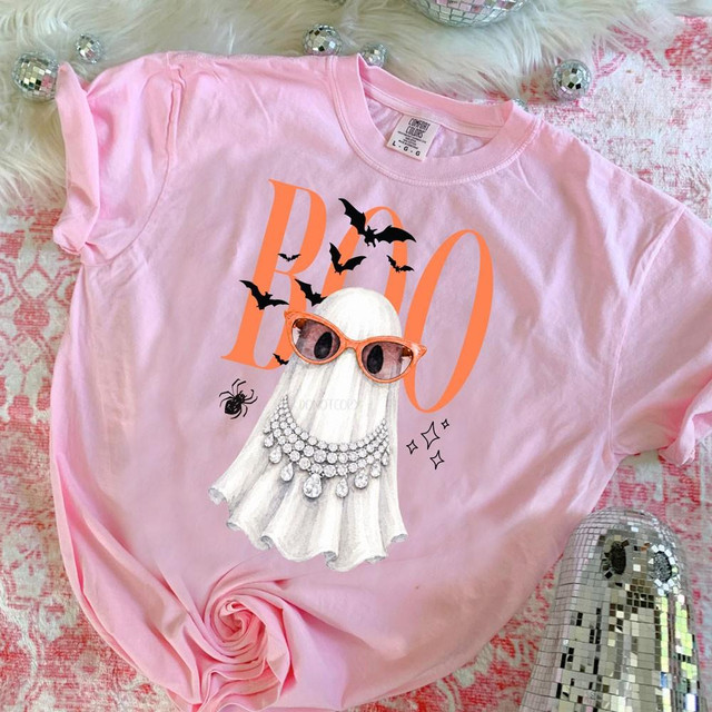 BOO Glam Ghost Halloween DTF Transfer, Boujee Halloween ghost design on a pink T-shirt with sunglasses and bling embellishments.