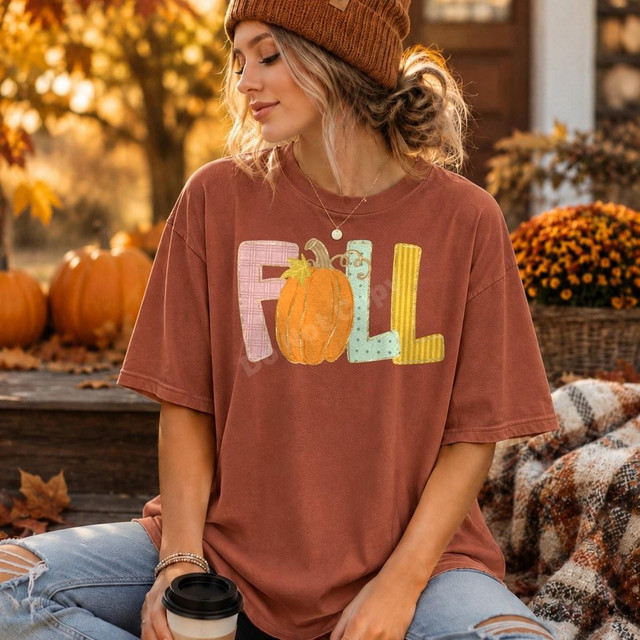 Fall Patchwork Pumpkin DTF Transfer | Cozy Autumn Season Design, women wearing a T-shirt with fall-themed patchwork pumpkin and letter design, outdoor autumn setting with pumpkins and fall foliage.