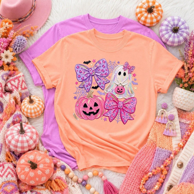 Pastel Ghost & Jack-O-Lantern DTF Transfer, Girly Halloween design with leopard bows on peach-colored T-shirt surrounded by pumpkins, fall flowers, and knitted accessories.