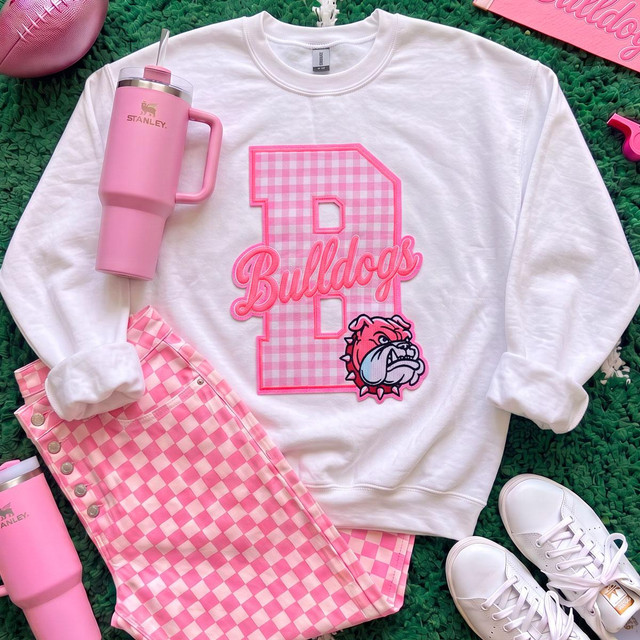 Pink Gingham Bulldogs Appliqué Embroidered Patch, pink and white checkered bulldog applique patch with embroidered text 'Bulldogs' and a bulldog mascot on a white sweatshirt.