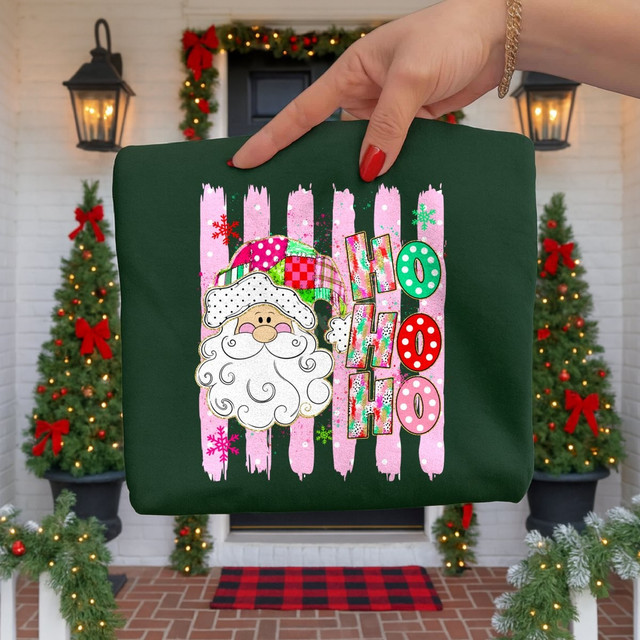 Ho Ho Ho Santa face DTF transfer with patchwork hat and pink brush stripe background on dark green shirt