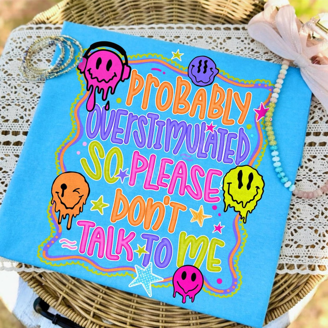 Probably Overstimulated So Please Don't Talk To Me DTF transfer with colorful drippy smiley faces and retro hand-lettered text