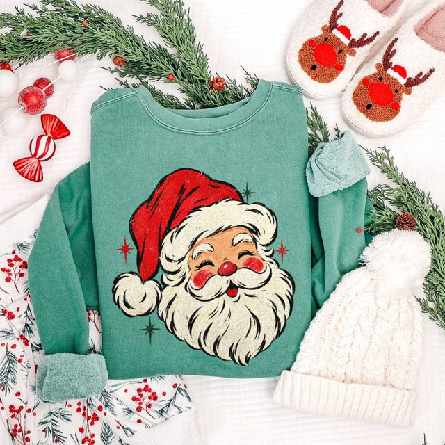 Retro vintage Santa Claus face DTF transfer with red hat and sparkle stars, printed on a green sweatshirt
