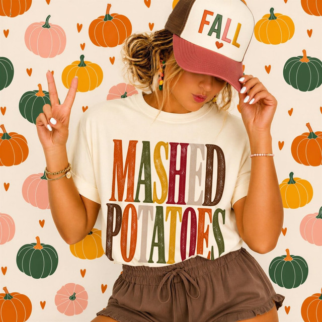 Mashed Potatoes DTF transfer with bold distressed retro lettering in fall colors on a cream t-shirt