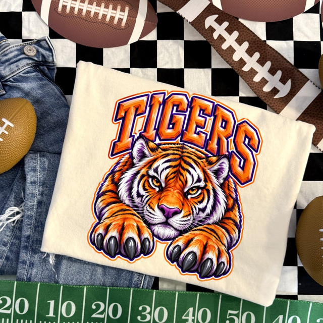 Tigers DTF transfer featuring a realistic tiger illustration with paws forward and bold orange and purple team lettering