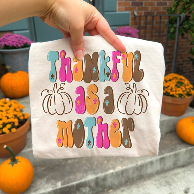 Thankful As A Mother DTF transfer with retro bubble lettering in pink, teal, orange, and brown, featuring two pumpkin outline graphics