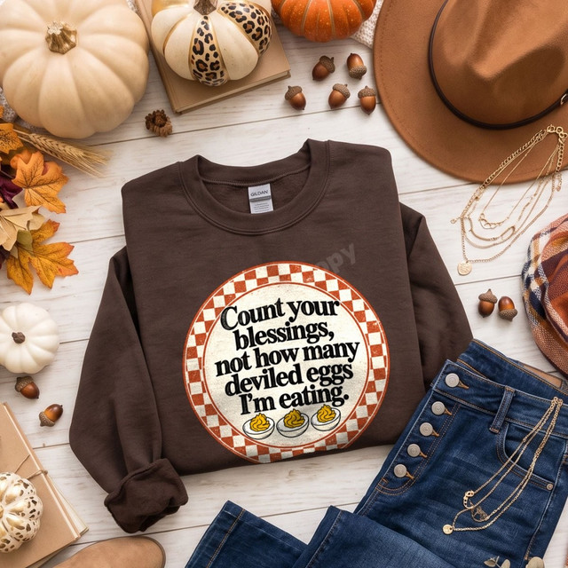 Count Your Blessings Not How Many Deviled Eggs I'm Eating DTF transfer with retro checkered circle design on brown sweatshirt