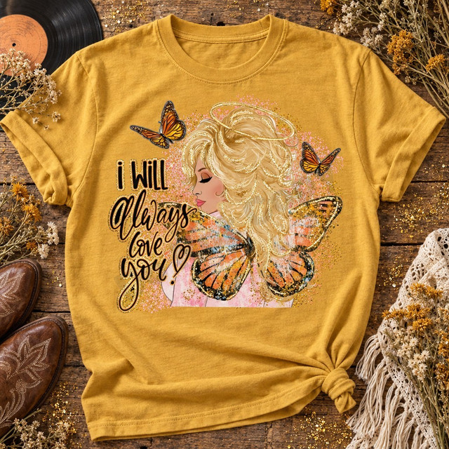 I Will Always Love You DTF transfer with illustrated blonde woman wearing a gold halo and monarch butterfly wings, surrounded by flying butterflies and gold glitter-style splatter Shown on a Mustard t-shirt.