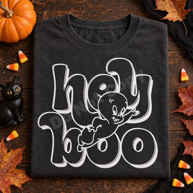 Hey Boo DTF transfer with chunky white bubble letters and a friendly waving ghost character peeking through the lettering Shown on a Pepper t-shirt.