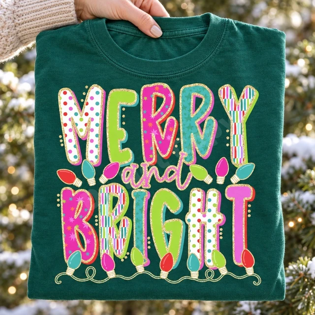 Merry and Bright Christmas DTF transfer with bold candy-colored patterned block letters outlined in gold glitter and colorful string lights Shown on a Emerald t-shirt.
