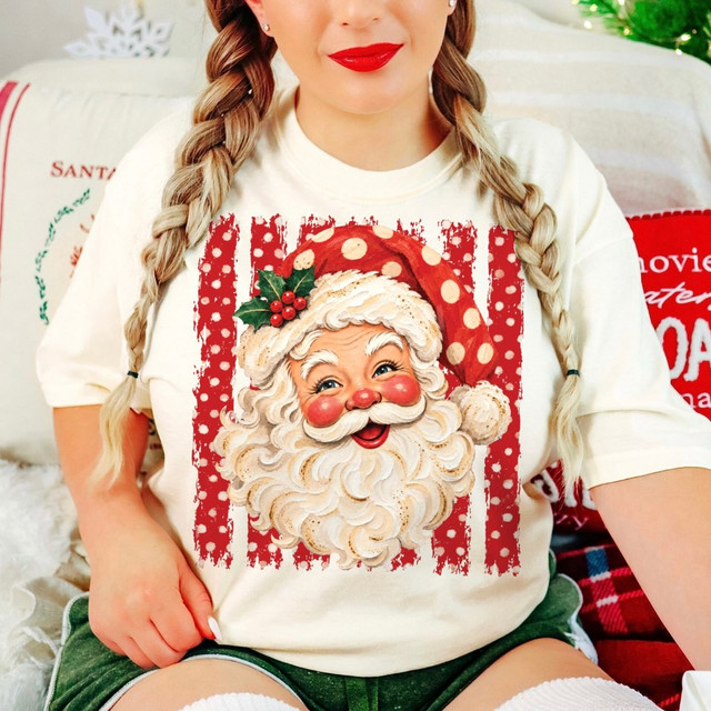 Vintage-style Santa Claus face DTF transfer with holly and red polka dot stripes on a cream shirt