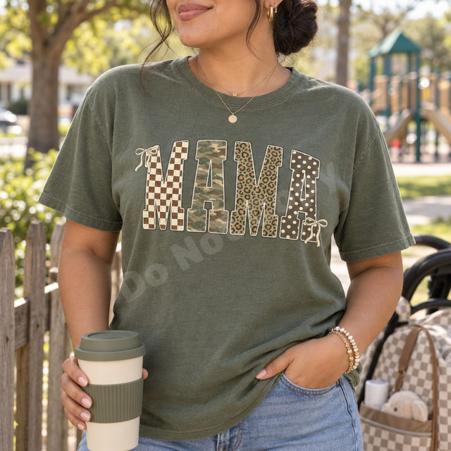 MAMA DTF transfer in block letters with checkerboard, camo, leopard, and polka dot patterns and cream bow accents Shown on a Moss t-shirt.
