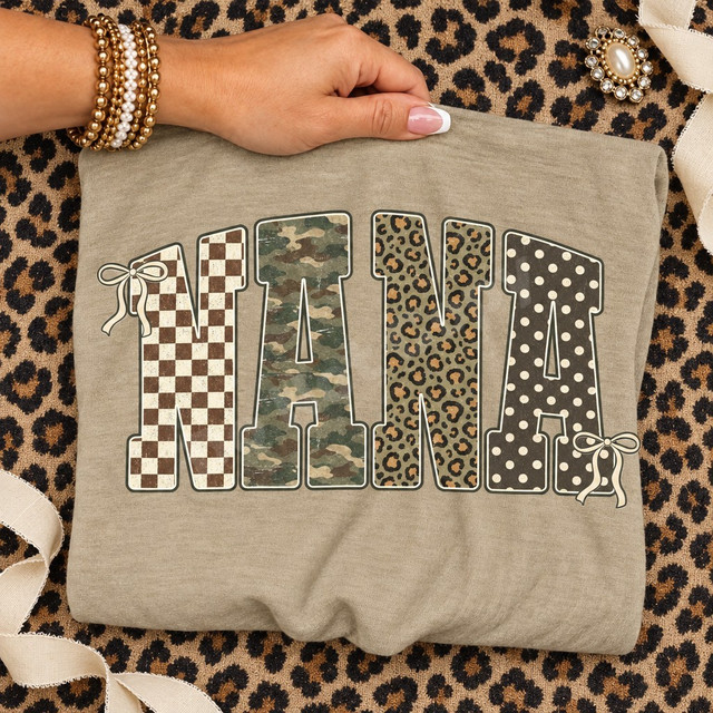 NANA block-letter DTF transfer in checkerboard, camo, leopard, and polka dot patterns with cream ribbon bow accents Shown on a Hemp t-shirt.