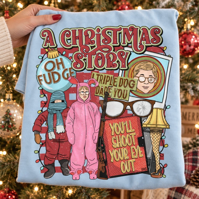 A Christmas Story retro-style DTF transfer collage featuring the pink bunny suit, leg lamp, cracked glasses, BB gun, and You'll Shoot Your Eye Out VHS cover art Shown on a Ice Blue t-shirt.