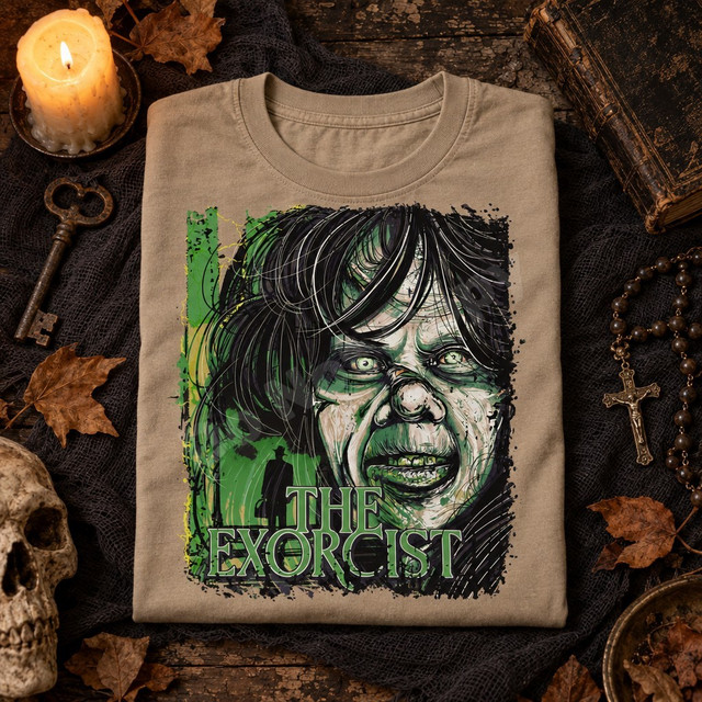 The Exorcist DTF transfer with grungy green and black distressed illustration of a demonic possessed face and a shadowy figure in a hat before a lit doorway Shown on a Sandstone t-shirt.