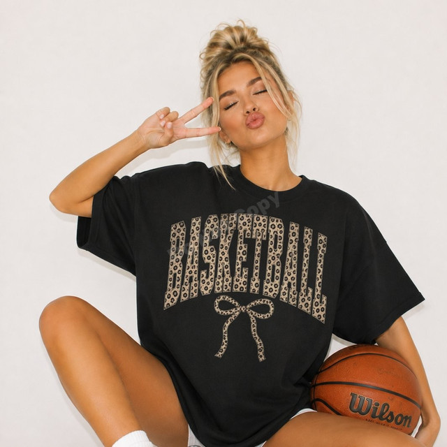 Basketball DTF transfer with arched leopard print lettering and a leopard print bow on a black oversized tee