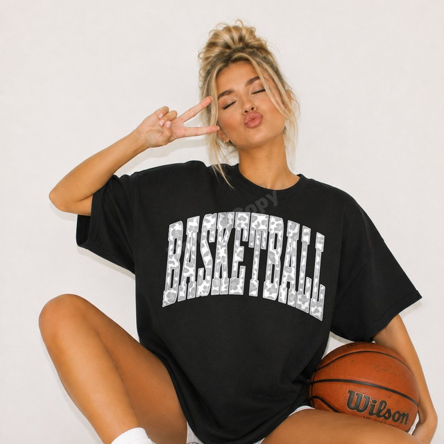 BASKETBALL DTF transfer with arched block lettering filled in gray and white camo print on a black shirt