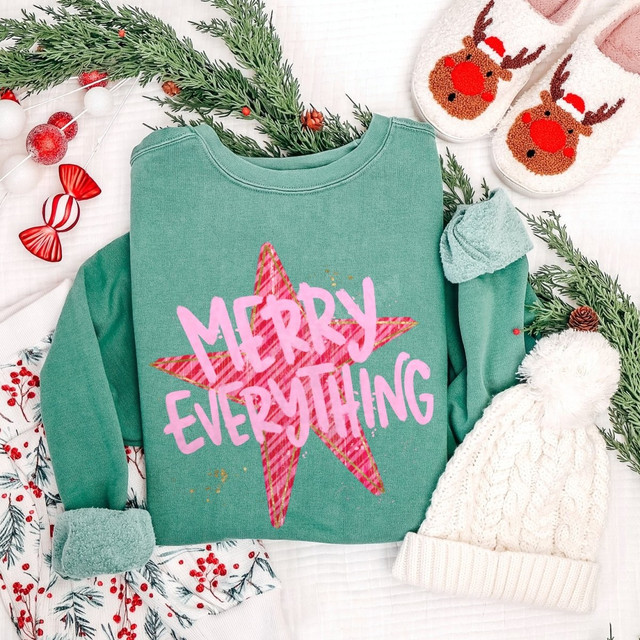 Merry Everything DTF transfer with pink script lettering over a plaid red star design on a green sweatshirt