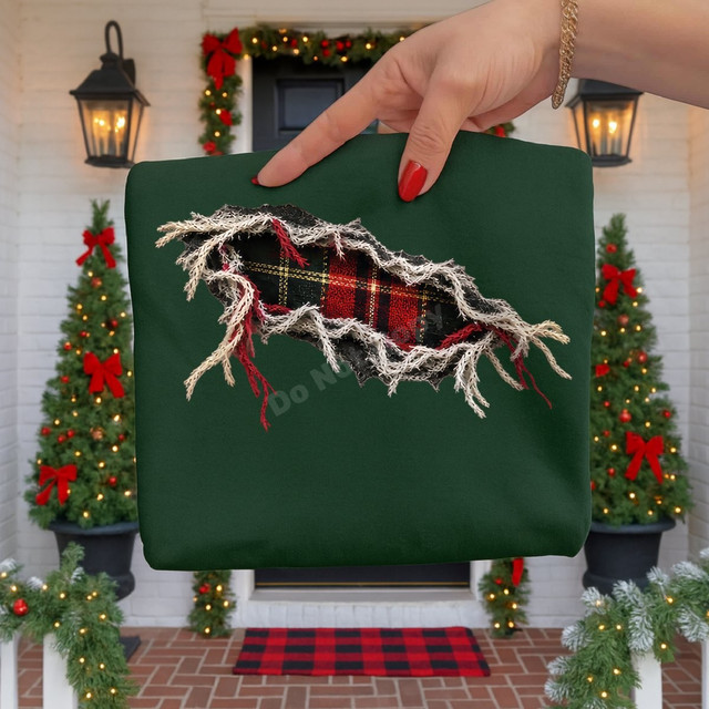 Torn fabric effect DTF transfer revealing red, black, and gold tartan plaid underneath on a green shirt