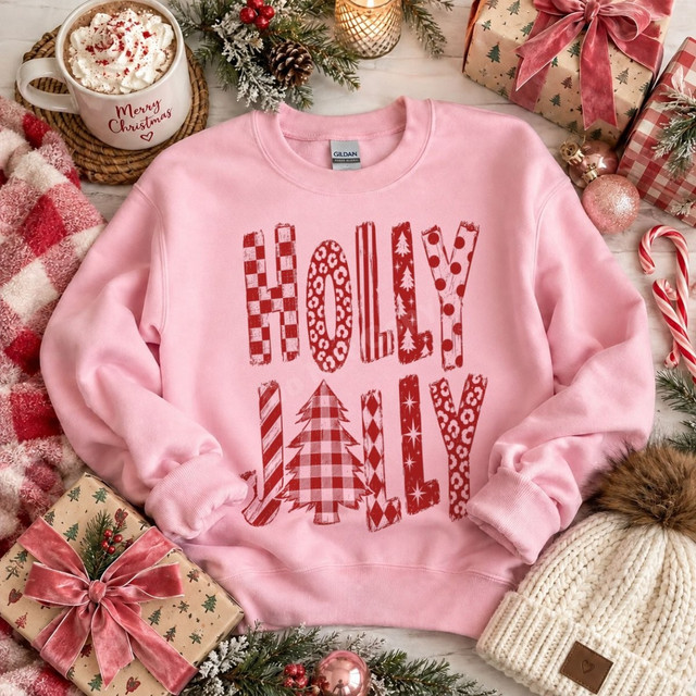 Holly Jolly Christmas DTF transfer in distressed red mixed-pattern lettering with a plaid Christmas tree, shown on a pink sweatshirt