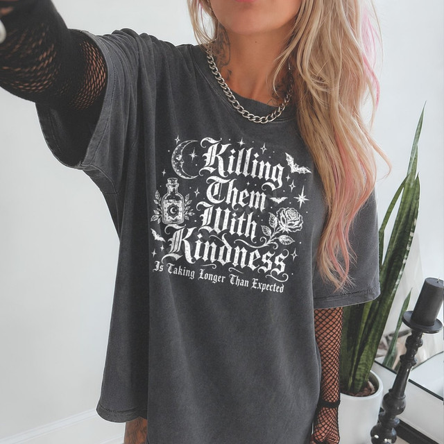 Killing Them With Kindness Is Taking Longer Than Expected DTF transfer with gothic lettering, crescent moon, potion bottle, rose, and bats on a dark shirt