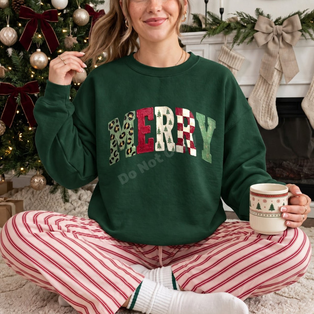 Merry Christmas DTF transfer with mixed leopard, plaid, checkerboard, and tree print lettering on a green sweatshirt