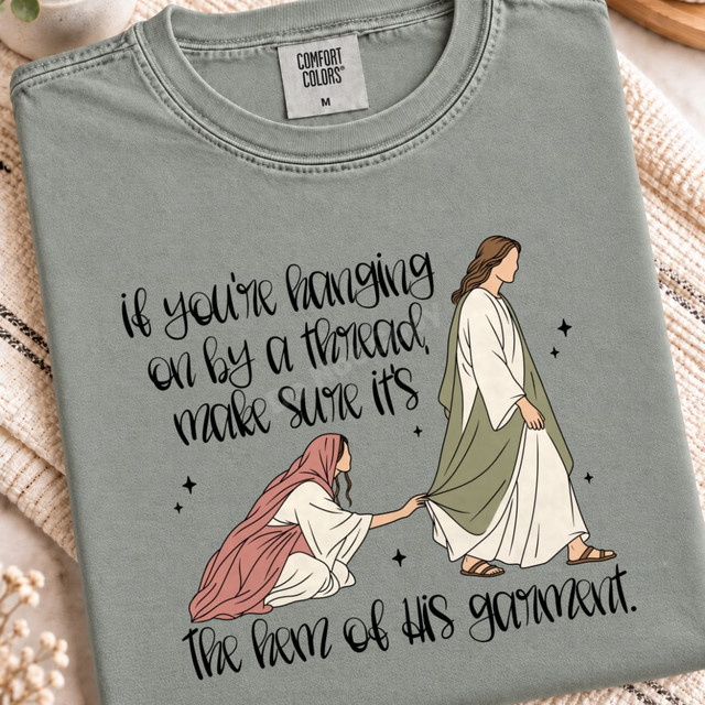 If You're Hanging On By A Thread Make Sure It's The Hem Of His Garment faith DTF transfer with illustration of a woman reaching for Jesus's robe