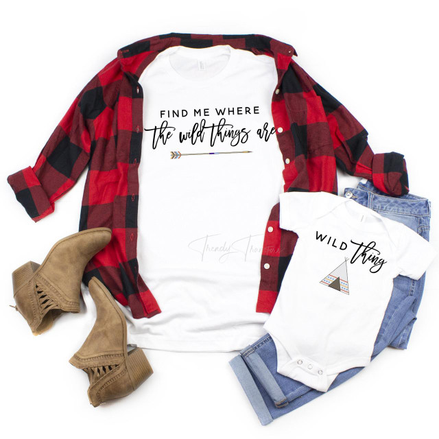 Wild thing mommy and me sublimation transfer, matching white t-shirts with 'Find me where the wild things are' and 'Wild thing' designs, paired with a red plaid shirt, jeans, and beige ankle boots for a coordinated mother and daughter outfit.