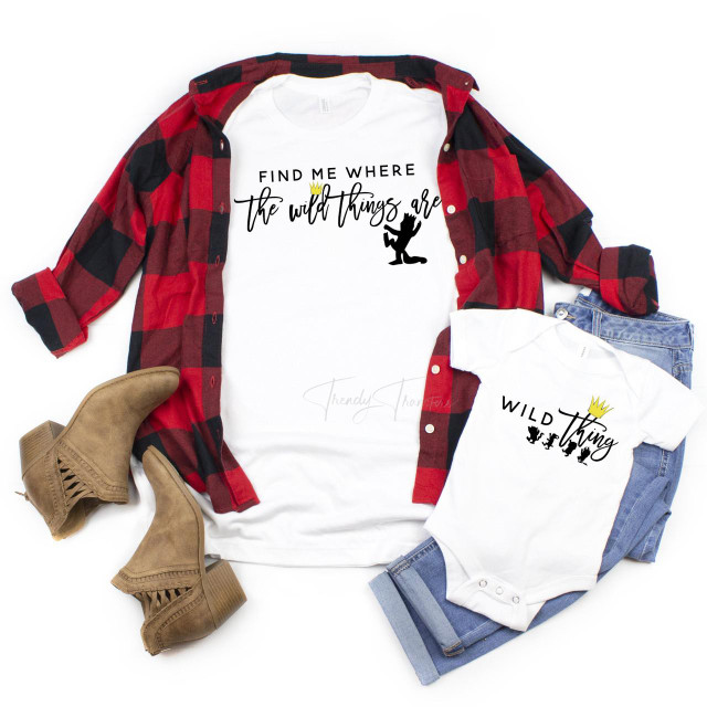 Wild Thing book edition mommy and me sublimation transfer, white T-shirts with wild thing graphic and text, paired with blue jeans, a red and black checkered shirt, beige ankle boots.