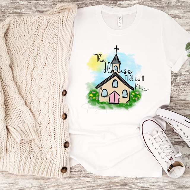 The house that built me bible church religious sublimation transfer, artistic graphic T-shirt with a church illustration and colorful watercolor background.