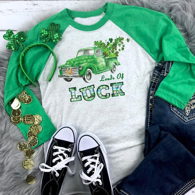 Loads Of Luck St. Patricks Day Screen Print Heat Transfer, green truck with shamrocks and leprechaun hat on a white and green long sleeve shirt, St. Patrick's Day themed apparel display.