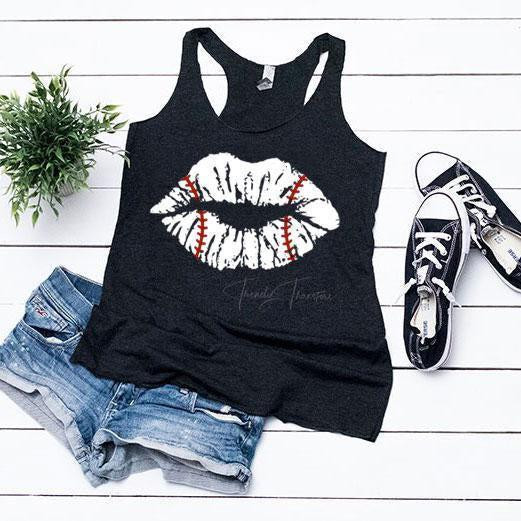 Baseball Lips FINAL STOCK Screen Print Heat Transfer, black tank top with white lips and baseball stitching design, paired with denim shorts and sneakers for stylish casual wear.