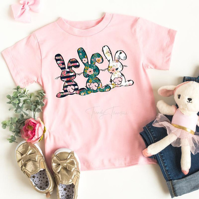 Easter Bunnies YOUTH Screen Print Heat Transfer, pink youth t-shirt with colorful bunny illustrations for Easter celebration.