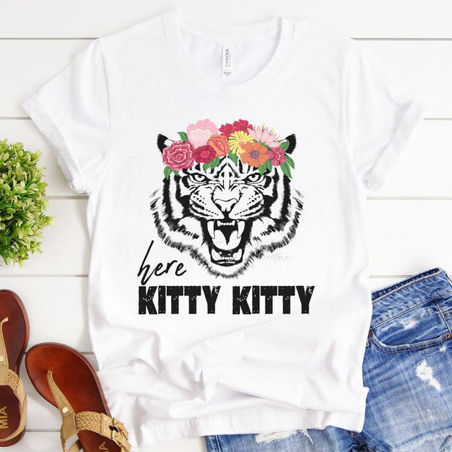 Here Kitty Kitty Sublimation Transfer, white T-shirt with a black tiger face design decorated with a colorful floral crown and the text 'here KITTY KITTY' printed below.