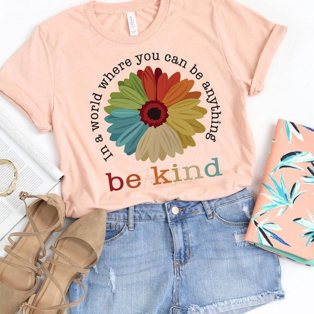 In a World Where You Can Be Anything Be Kind Screen Print Heat Transfer T-shirt, pink casual T-shirt with a colorful flower design and inspirational quote.