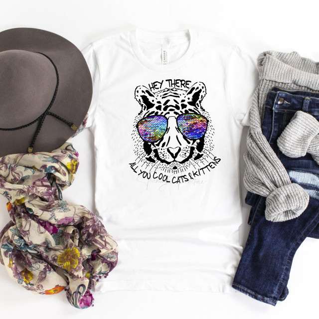 Tiger King Fan Art T-Shirt, a white sublimation transfer shirt featuring a line art illustration of a tiger wearing colorful sequin sunglasses with the text 'Hey there all you cool cats and kittens'.
