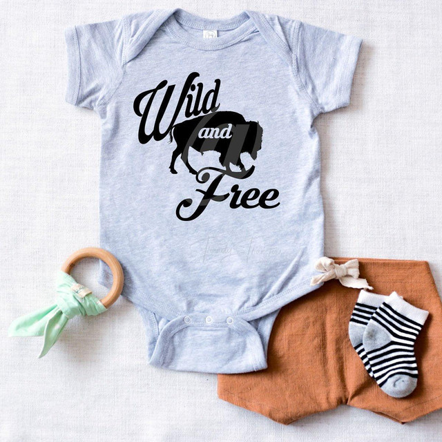 Wild and Free Buffalo FINAL STOCK - INFANT Screen Print Heat Transfer, baby onesie with a buffalo silhouette and the text 'Wild and Free' in black and white.