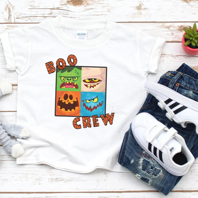 Boo Crew Sublimation Transfer, colorful cartoon Halloween ghost faces with the words 'BOO CREW' on a white T-shirt, next to denim jeans and white sneakers.