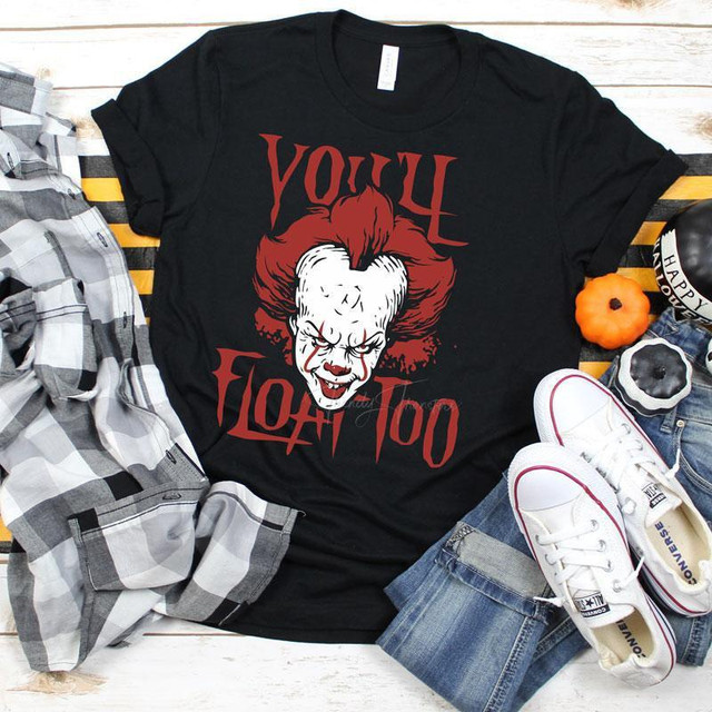 You'll Float Too Screen Print Heat Transfer, horror-themed t-shirt featuring a creepy clown face and the text 'You'll Float Too' in bold red letters.