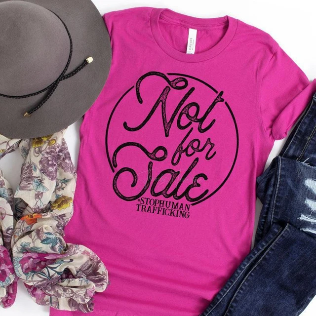 Not For Sale Screen Print Transfer T-shirt, pink casual t-shirt with black text design, along with a gray hat, floral scarf, and distressed denim jeans.