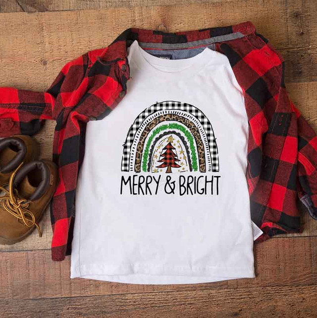 Merry And Bright Christmas Rainbow Sublimation Transfer, on a white T-shirt with a festive rainbow and Christmas tree design.