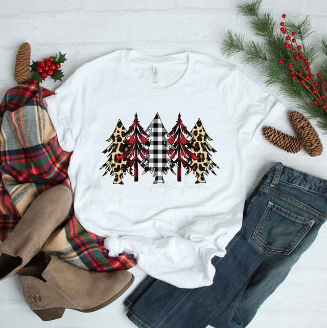Patterned Christmas Trees Sublimation Transfer, white T-shirt with multiple Christmas tree designs featuring plaid, leopard print, and buffalo check patterns.