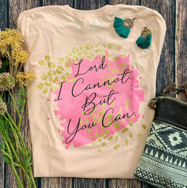 Lord I Cannot But You Can Screen Print Transfer, T-shirt with motivational quote and floral design, pink and yellow colors, displayed with earrings and accessories.