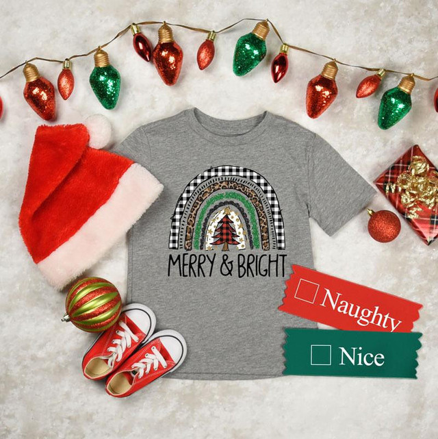 Merry and Bright Rainbow YOUTH Screen Print Heat Transfer, holiday-themed gray t-shirt with rainbow and Christmas tree design, surrounded by Christmas decorations and gifts.