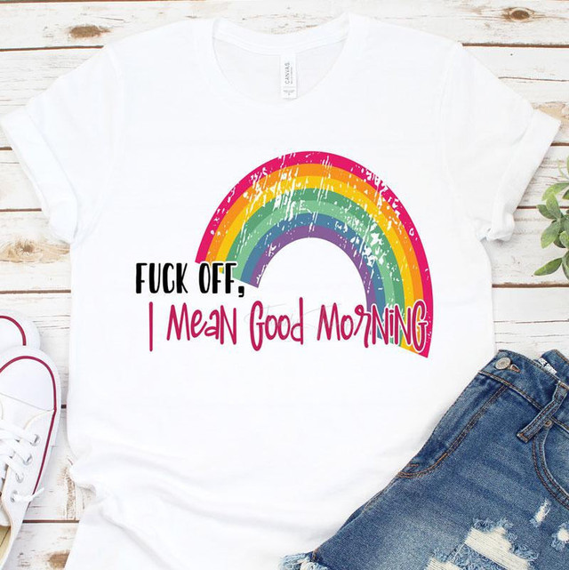 F*ck Off, I Mean Good Morning Sublimation Transfer T-Shirt with colorful rainbow design and humorous phrase on a flat lay of casual clothing and shoes.