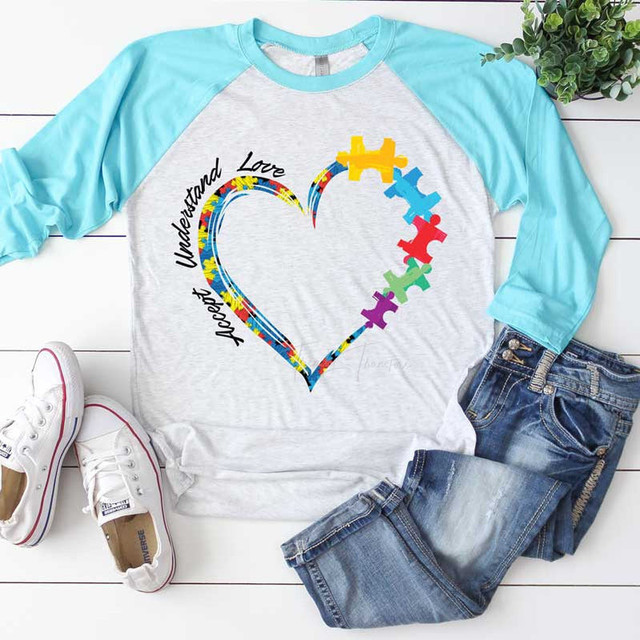 Accept Understand Love Sublimation Transfer, graphic of a colorful heart with puzzle pieces and the words 'Accept Unstand Love' on a casual gray and turquoise raglan t-shirt.