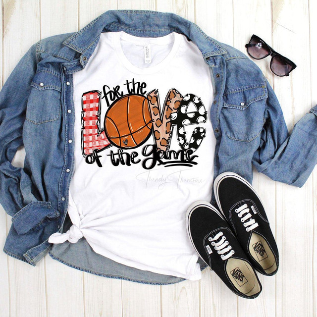 For The Love of The Game Basketball Screen Print Heat Transfer, graphic T-shirt with basketball, leopard print, polka dots, and plaid design, accompanied by a denim shirt, sunglasses, and Vans sneakers on a white wooden surface.
